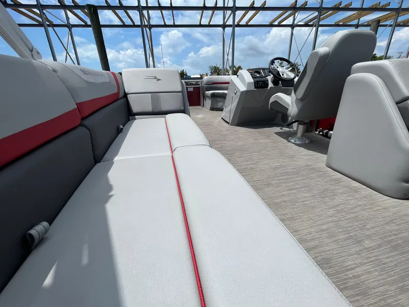 Slide: The Image of 2022 Bennington 22SSRCX pontoon boat interior with plush seating and modern helm. - 18