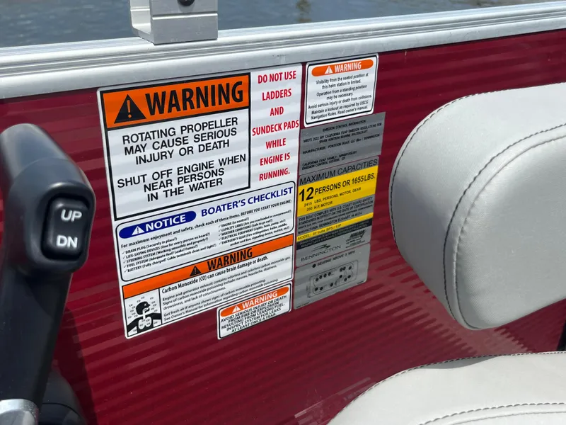 Slide: The Image of Warning labels and capacity information on a 2022 Bennington 22SSRCX boat. - 22