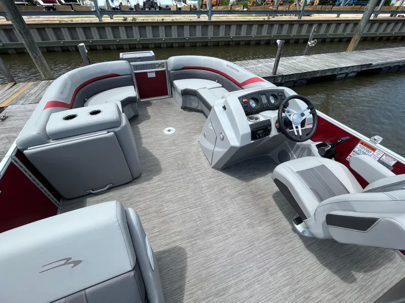 Slide: The Image of 2022 Bennington 22SSRCX pontoon boat interior with gray seating and steering console. - 5