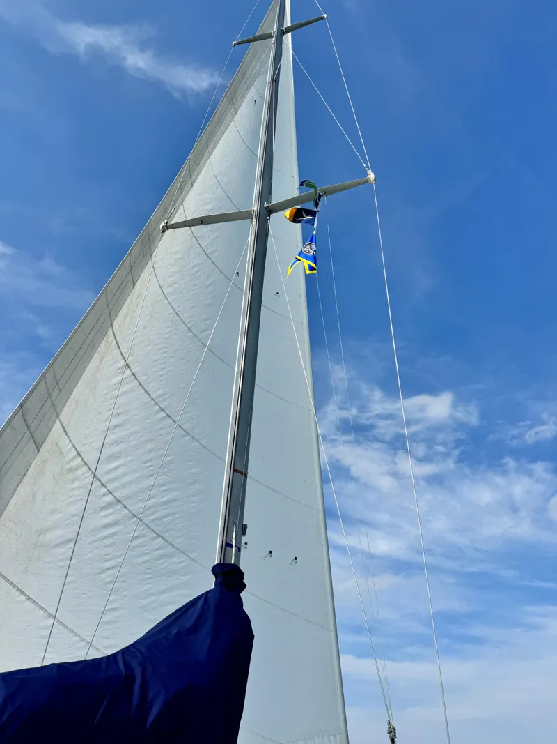 Slide: The Image of Sailboat mast and sail against blue sky, C&C 37 model, 1981. - 11