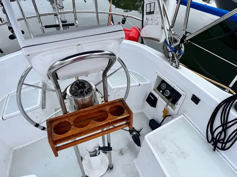 Slide: The Image of Cockpit of 1981 C&C 37 sailboat with steering wheel, compass, and control panel. - 15