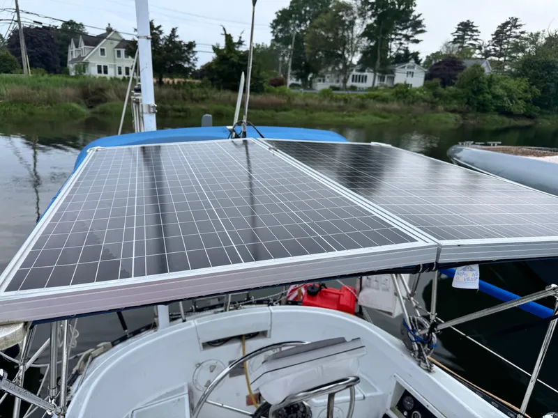 Slide: The Image of Solar panels on a 1981 C&C 37 sailboat, docked near waterfront homes. - 17