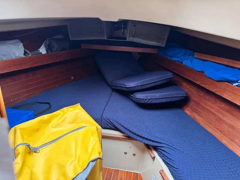 Slide: The Image of Interior cabin of a 1981 C&C 37 sailboat with blue cushions and wooden paneling. - 22