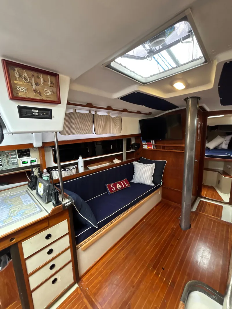 Slide: The Image of Interior of 1981 C&C 37 sailboat with cozy seating and navigation area. - 25