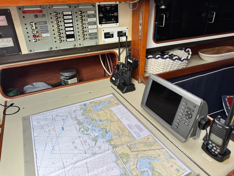 Slide: The Image of Navigation station on a 1981 C&C 37 sailboat with charts and electronics. - 30