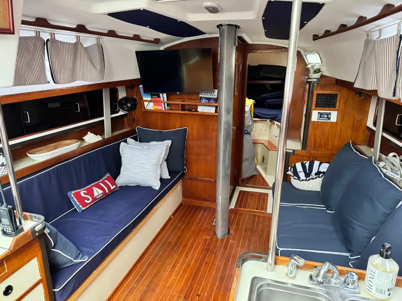 Slide: The Image of Interior of 1981 C&C 37 sailboat with cozy seating, wood finish, and nautical decor. - 32