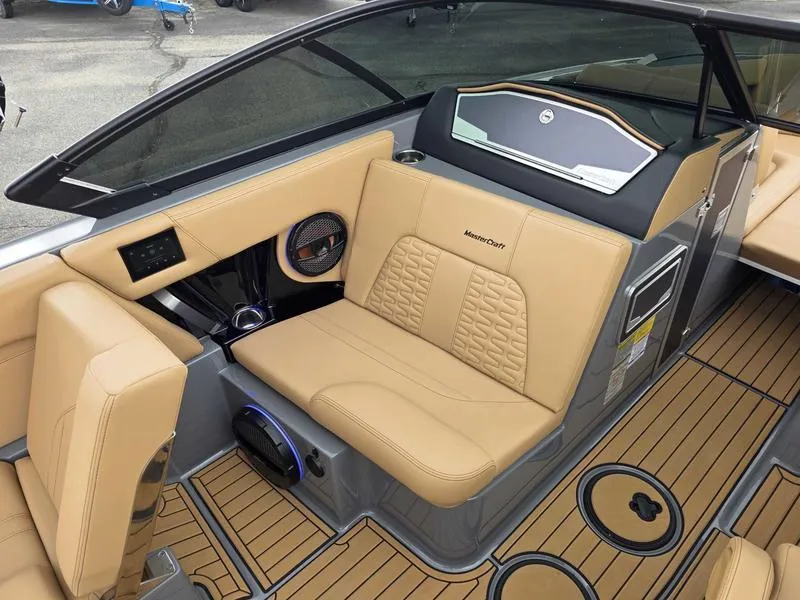 Slide: The Image of 2025 MasterCraft X24 boat interior with tan leather seating and modern dashboard design. - 11