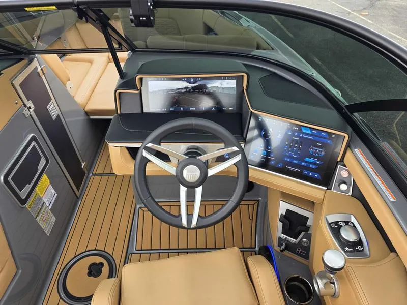 Slide: The Image of 2025 MasterCraft X24 boat cockpit with modern steering and digital displays. - 13
