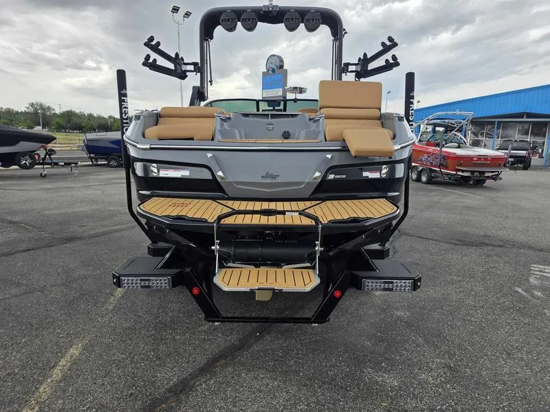 Slide: The Image of 2025 MasterCraft X24 boat with tan seating and sleek design, displayed outdoors. - 4