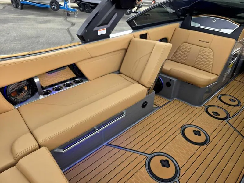 Slide: The Image of Luxurious interior of 2025 MasterCraft X24 boat with tan seating and wood-style flooring. - 9