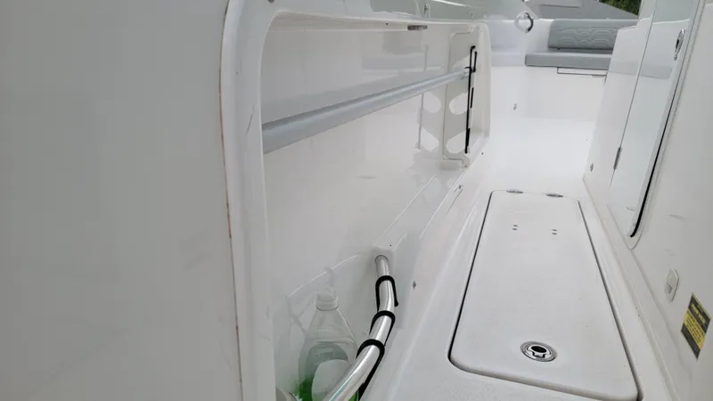 Slide: The Image of 2023 Twin Vee 260 CC GF boat interior, featuring storage compartment and seating area. - 13