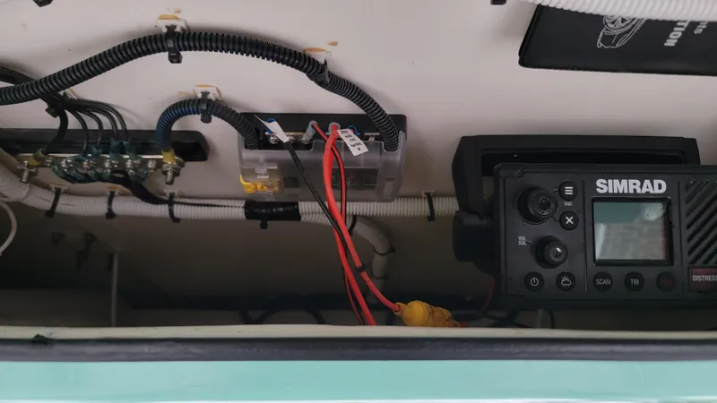 Slide: The Image of 2023 Twin Vee 260 CC GF boat electronics, featuring Simrad marine equipment and wiring setup. - 14