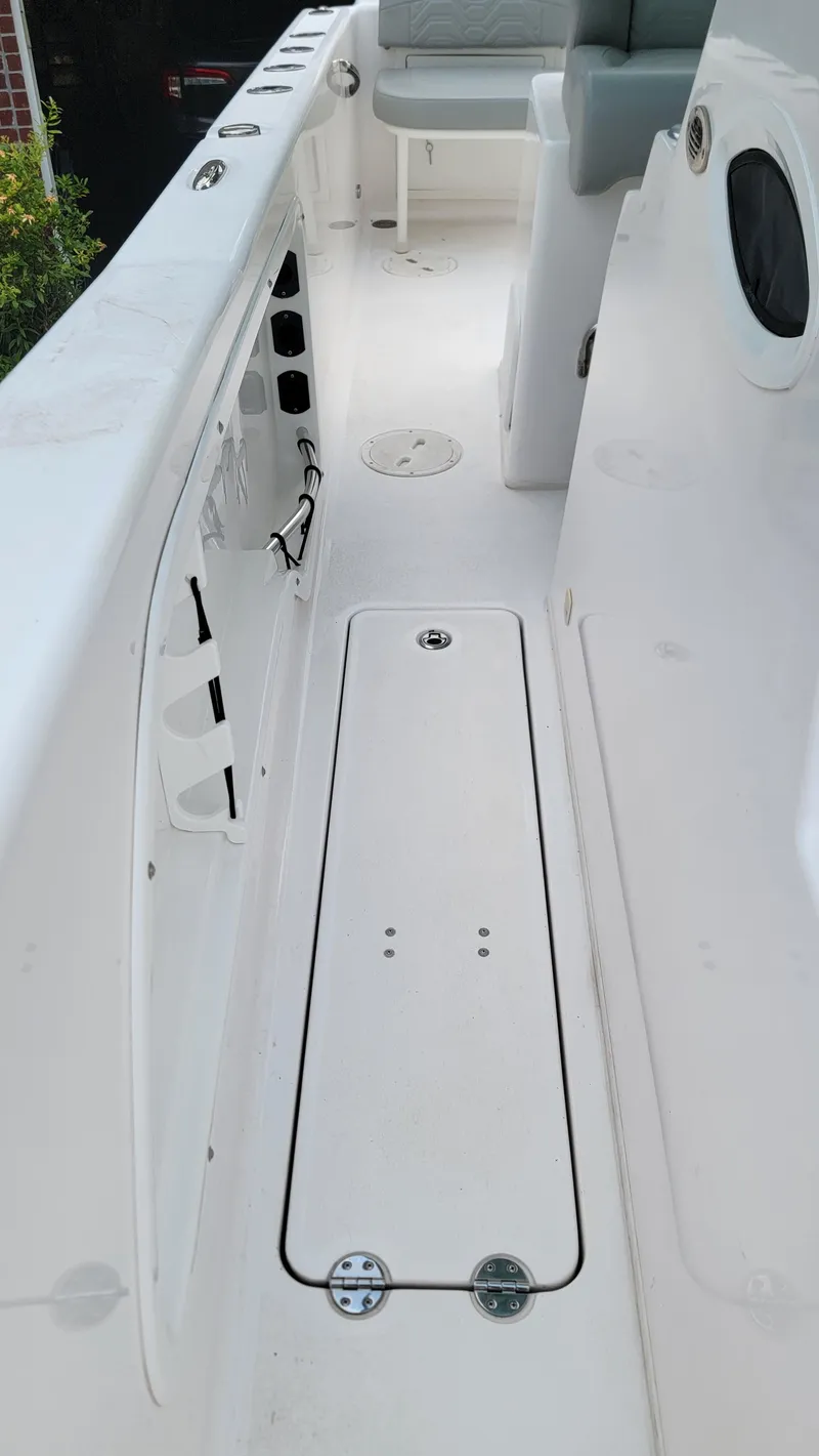 Slide: The Image of 2023 Twin Vee 260 CC GF boat interior, featuring sleek white deck and seating. - 17