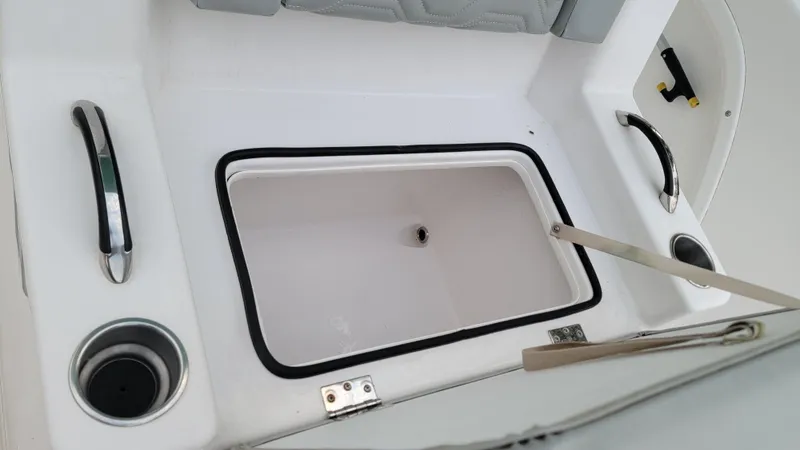 Slide: The Image of 2023 Twin Vee 260 CC GF boat storage compartment with cup holders and handles. - 18