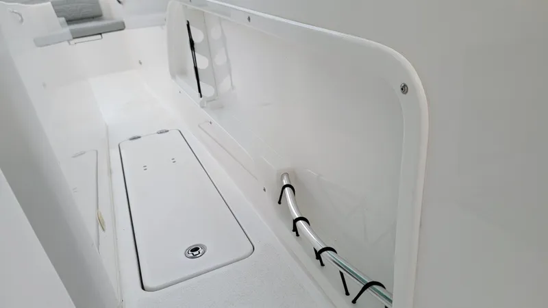 Slide: The Image of 2023 Twin Vee 260 CC GF boat interior, featuring storage compartment and seating area. - 25