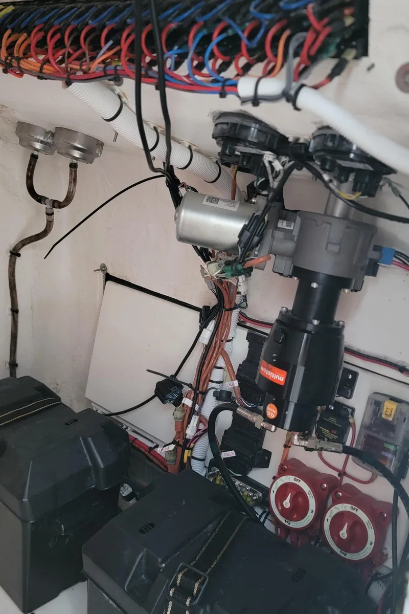 Slide: The Image of 2023 Twin Vee 260 CC GF boat wiring and electrical components in engine compartment. - 31