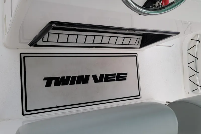 Slide: The Image of 2023 Twin Vee 260 CC GF boat interior with logo and seating area. - 33