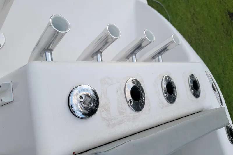 Slide: The Image of Rod holders on a 2023 Twin Vee 260 CC GF boat, featuring sleek metal design. - 34