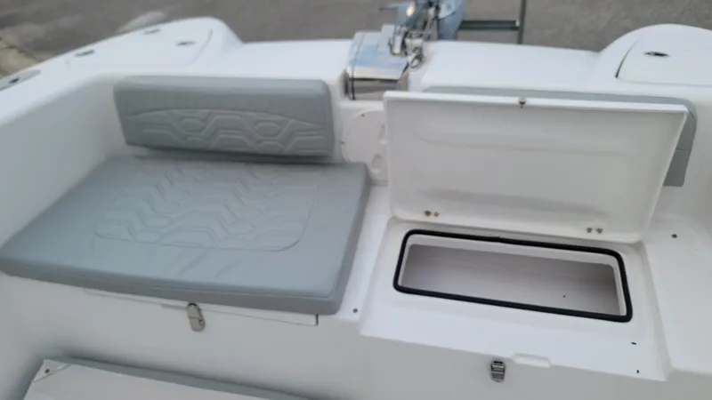 Slide: The Image of 2023 Twin Vee 260 CC GF boat interior with cushioned seating and open storage compartment. - 38