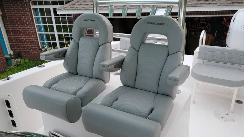 Slide: The Image of 2023 Twin Vee 260 CC GF boat seats, featuring gray leather upholstery and armrests. - 39