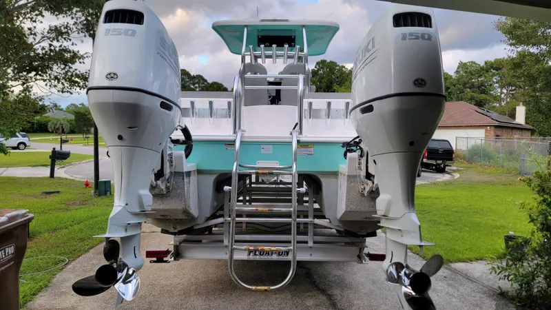 Slide: The Image of 2023 Twin Vee 260 CC GF boat with dual Suzuki 150 outboard motors on a trailer. - 4