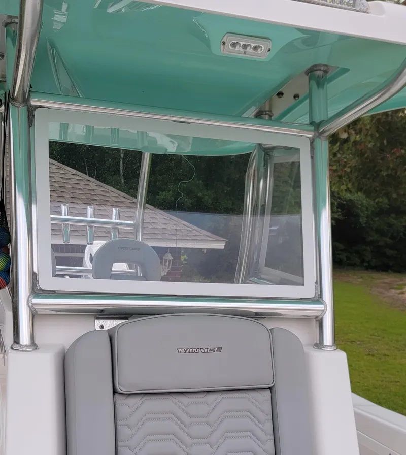 Slide: The Image of 2023 Twin Vee 260 CC GF boat interior with teal ceiling and gray seating. - 6