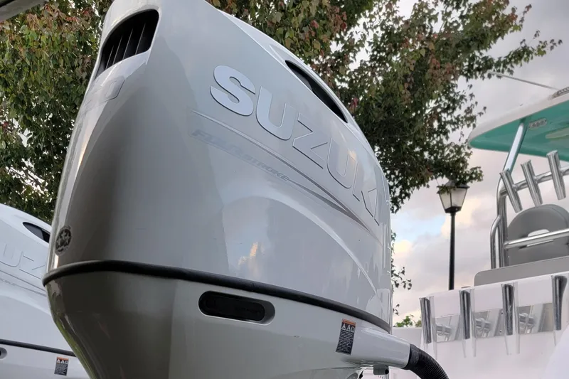 Slide: The Image of 2023 Twin Vee 260 CC GF boat with Suzuki outboard motor, outdoor setting. - 7