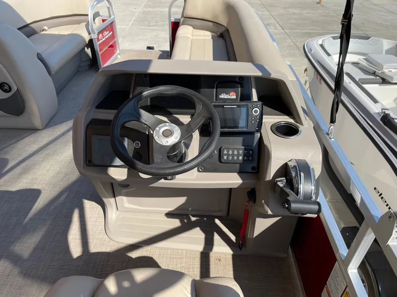 Slide: The Image of 2024 Sun Tracker Party Barge 18 DLX helm with steering wheel and control panel. - 3