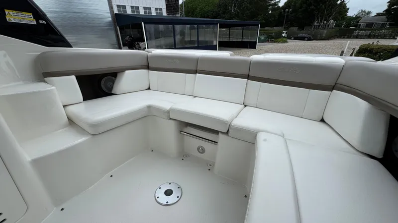 Slide: The Image of 2013 Sea Ray 270 SLX boat interior with white cushioned seating. - 12