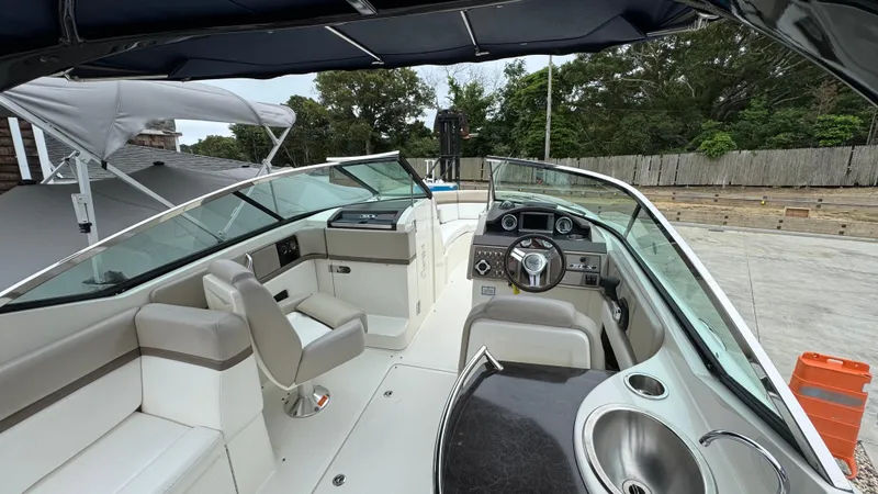 Slide: The Image of 2013 Sea Ray 270 SLX boat interior with helm, seating, and windshield. - 16
