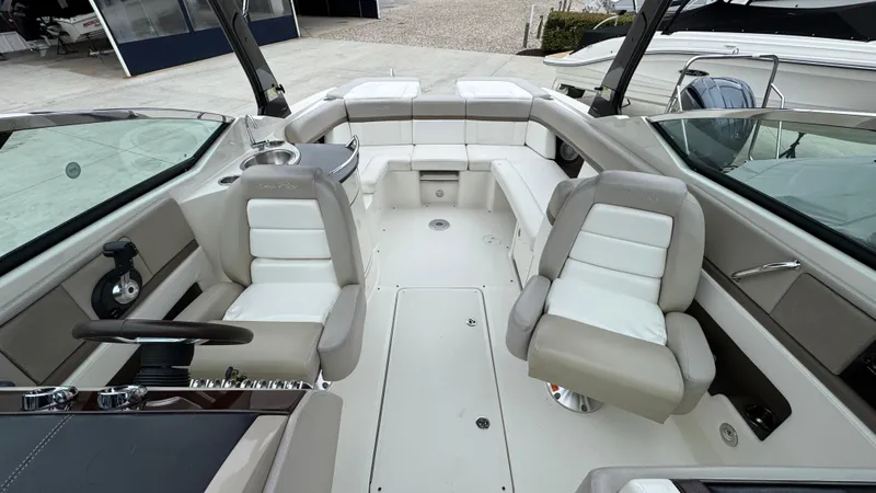Slide: The Image of 2013 Sea Ray 270 SLX boat interior with beige and white seating. - 18