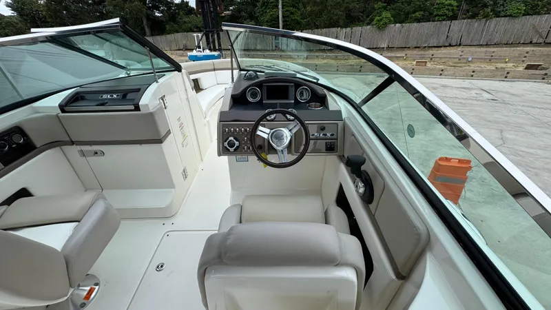 Slide: The Image of Interior view of 2013 Sea Ray 270 SLX boat cockpit with steering wheel and seating. - 20