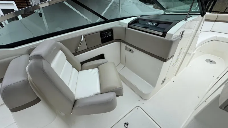 Slide: The Image of 2013 Sea Ray 270 SLX boat interior with beige seating and dashboard. - 21
