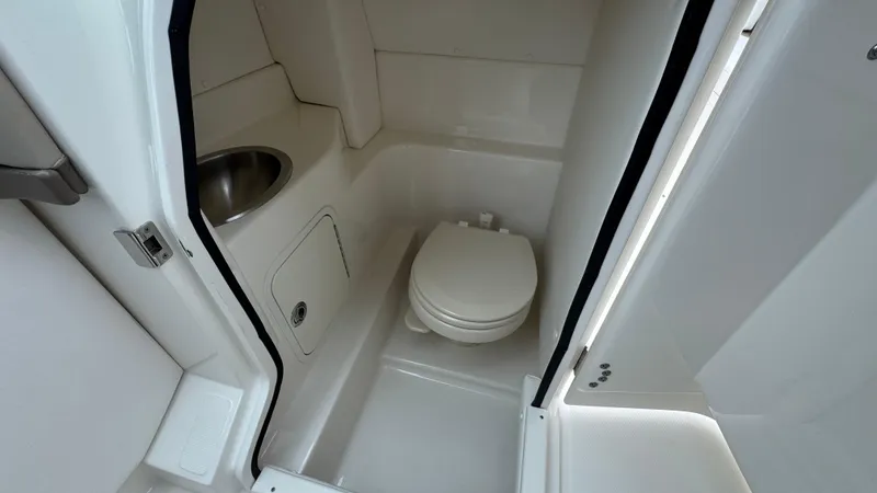 Slide: The Image of 2013 Sea Ray 270 SLX boat bathroom with toilet and sink. - 22
