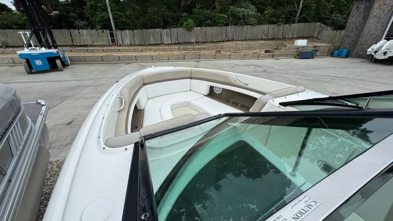 Slide: The Image of 2013 Sea Ray 270 SLX boat with spacious seating, docked outdoors. - 24