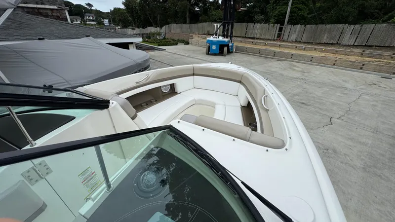 Slide: The Image of 2013 Sea Ray 270 SLX boat with spacious seating, docked in a marina. - 26