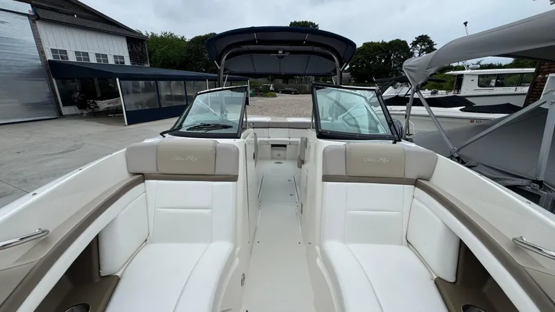 Slide: The Image of 2013 Sea Ray 270 SLX boat interior with white seating and open deck. - 27