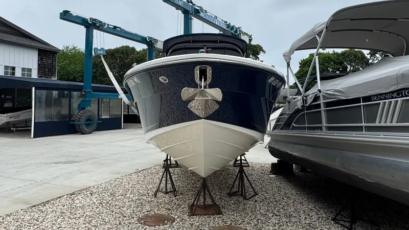 Slide: The Image of 2013 Sea Ray 270 SLX boat on stands in a marina setting. - 3