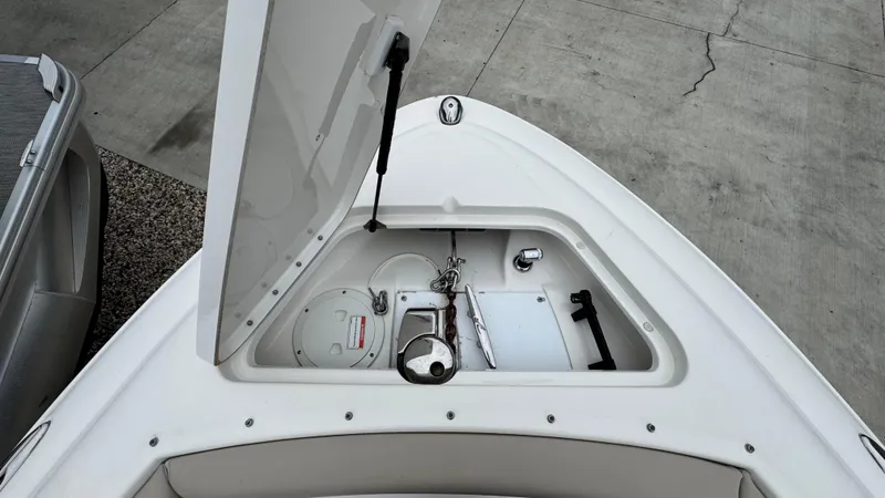Slide: The Image of 2013 Sea Ray 270 SLX boat anchor compartment with open hatch, showing storage and equipment. - 30