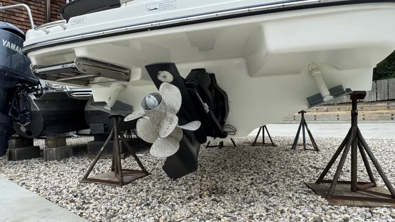 Slide: The Image of 2013 Sea Ray 270 SLX boat on stands, showing propeller and hull details. - 5