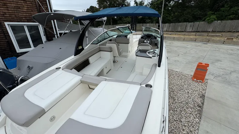 Slide: The Image of 2013 Sea Ray 270 SLX boat with blue canopy, docked outdoors. - 9