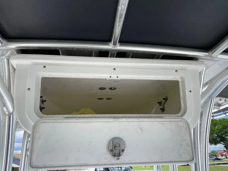 Slide: The Image of 2021 Cape Horn 22 OS boat storage compartment with open hatch and latch mechanism. - 11
