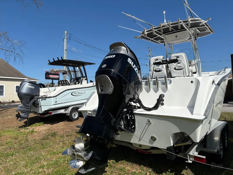 Slide: The Image of 2021 Cape Horn 22 OS boat with Suzuki outboard motor, parked beside a Robalo boat. - 3