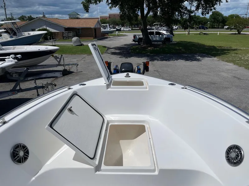 Slide: The Image of 2021 Cape Horn 22 OS boat deck with open storage compartments, parked outdoors. - 9