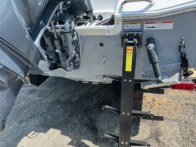 Slide: The Image of 2025 Wellcraft 222 Fisherman boat stern with motor and ladder, parked on pavement. - 12