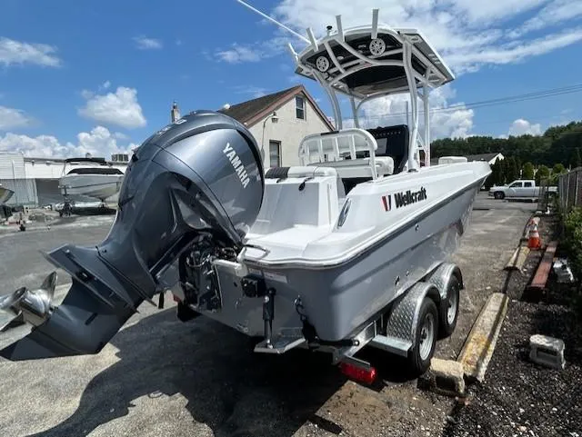 Slide: The Image of 2025 Wellcraft 222 Fisherman boat with Yamaha engine on trailer, parked outdoors. - 2