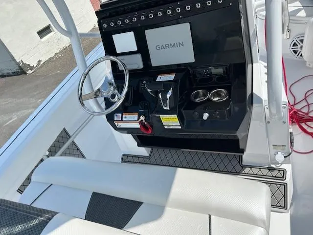 Slide: The Image of 2025 Wellcraft 222 Fisherman boat console with Garmin system and steering wheel. - 7