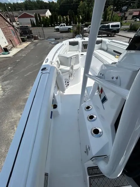 Slide: The Image of 2025 Wellcraft 222 Fisherman boat, white interior, docked in a marina setting. - 8