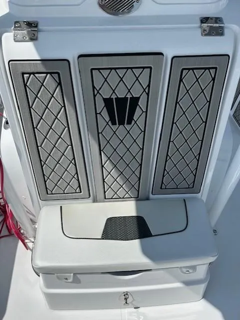 Slide: The Image of 2025 Wellcraft 222 Fisherman boat seat with diamond-patterned upholstery and storage compartment. - 9