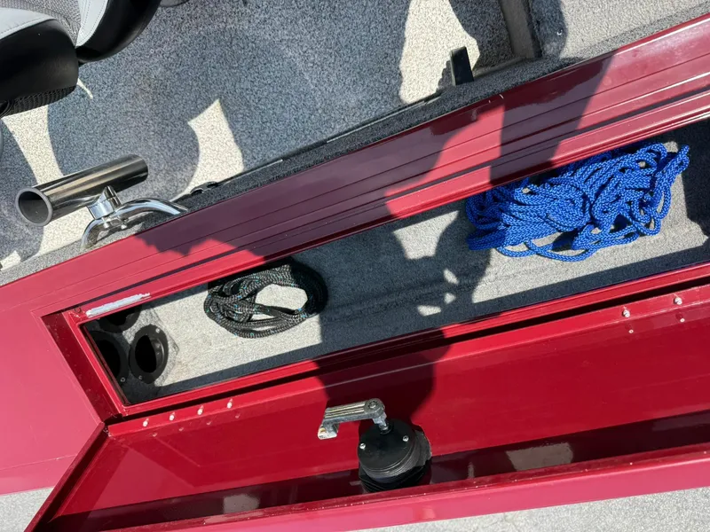 Slide: The Image of Open storage compartment on 2012 Tracker Targa V-18 Combo boat with blue rope inside. - 16